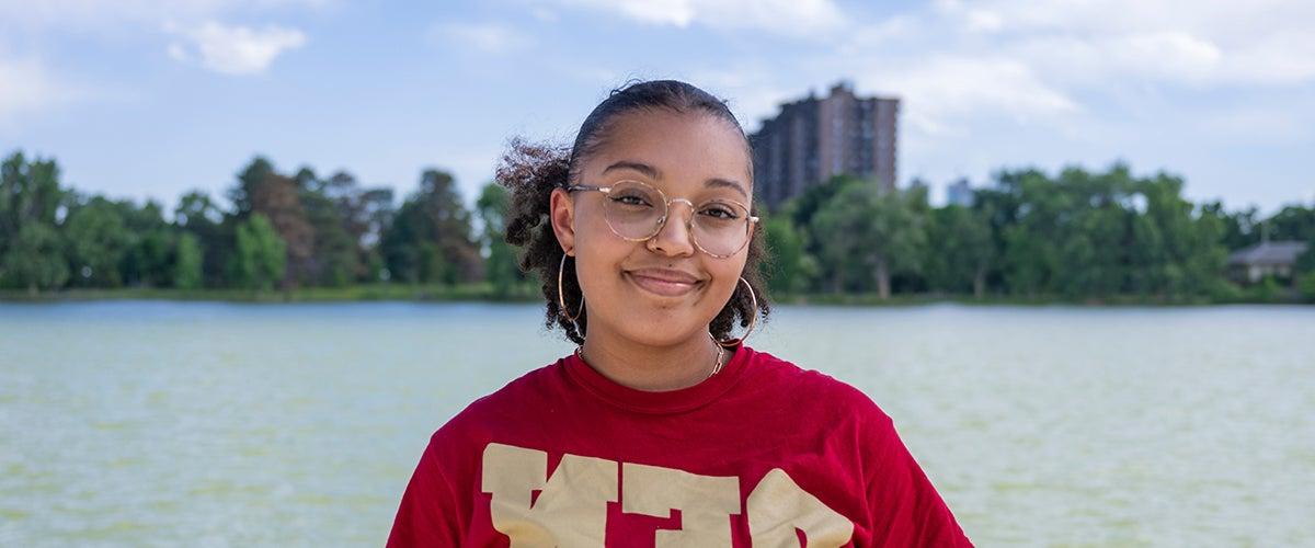 student smiling outside